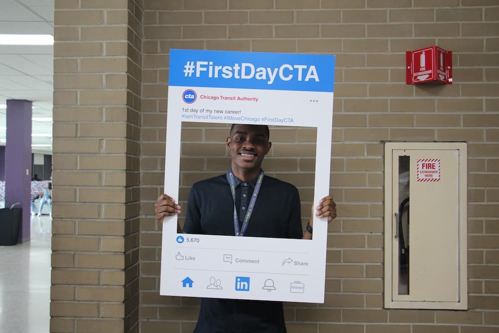 Intern holding a sign reading First Day CTA