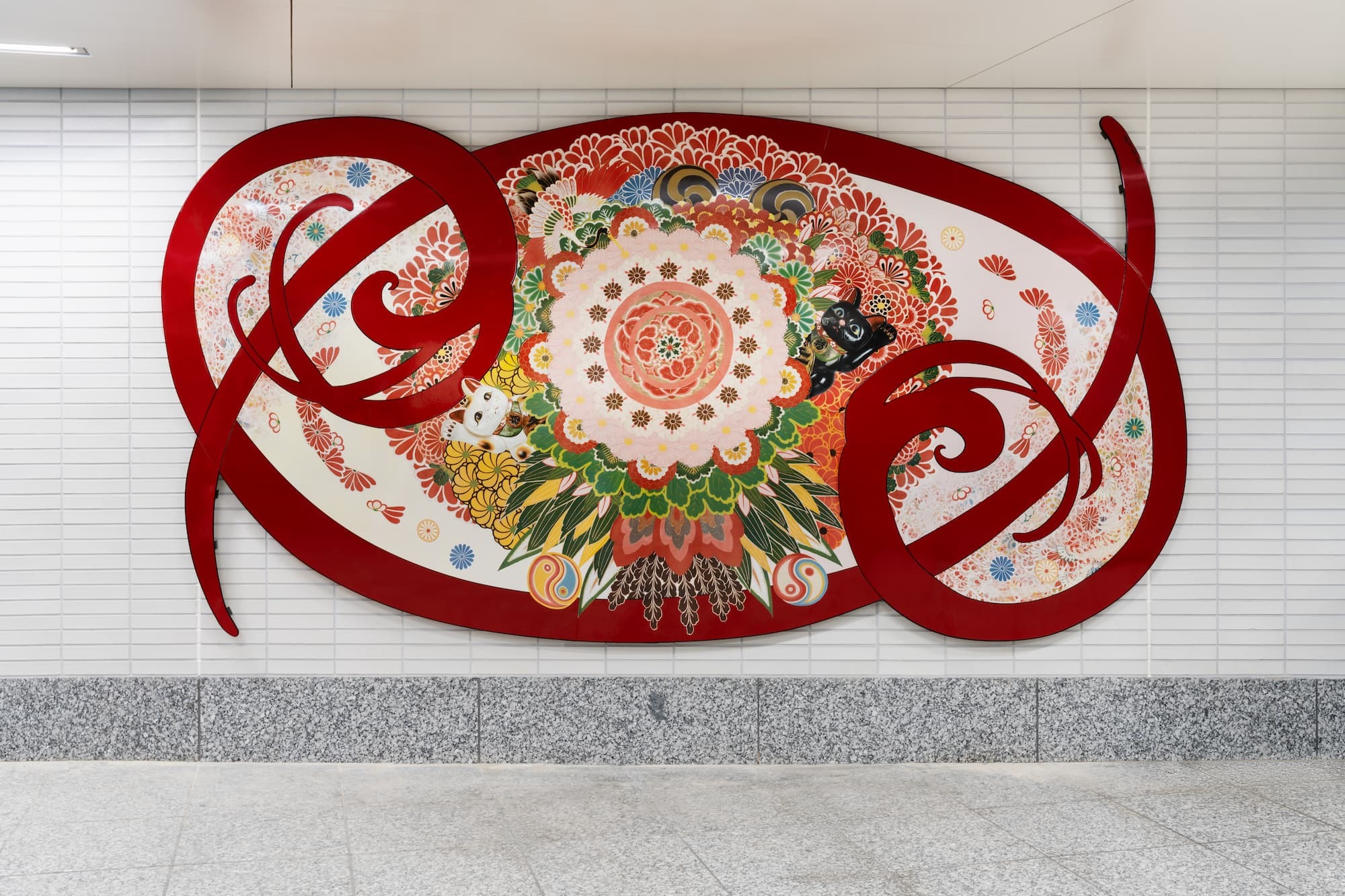 A looping porcelain art object mounted on the station wall.