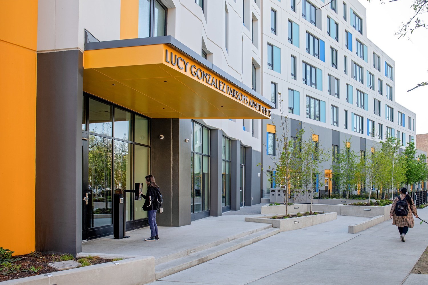 Photo of entrance with awning that reads Lucy Gonzalez Parsons Apartments