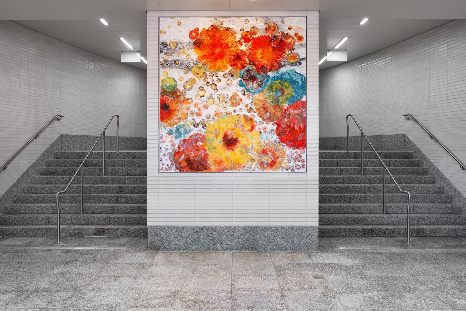 A lively, colorful mosaic flanked by station stairs.