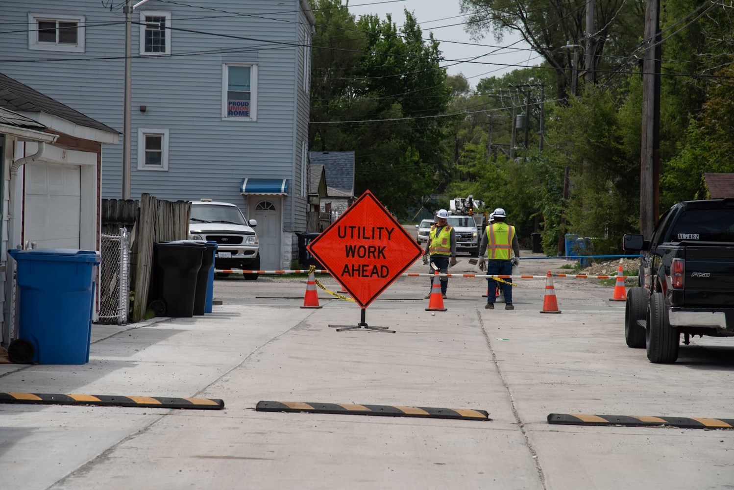 Road closed with an orange sign reading "Utility Work Ahead"
