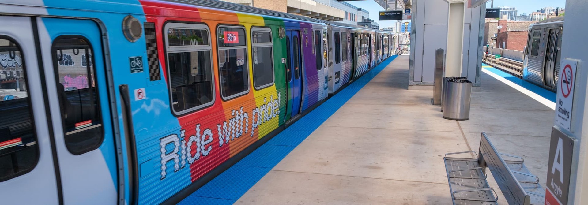Colorful train cars with the message "Ride with pride!"
