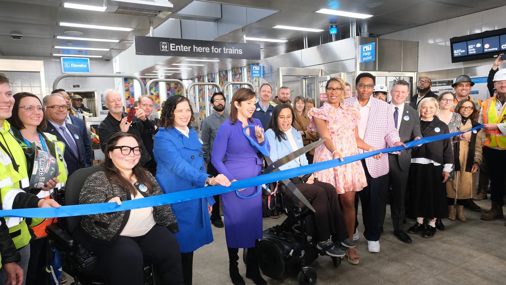 Racine station ribboncutting ceremony with guests lined up.
