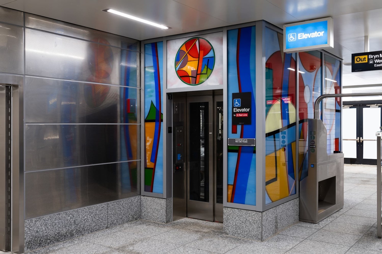 Colorful glass elevator enclosure