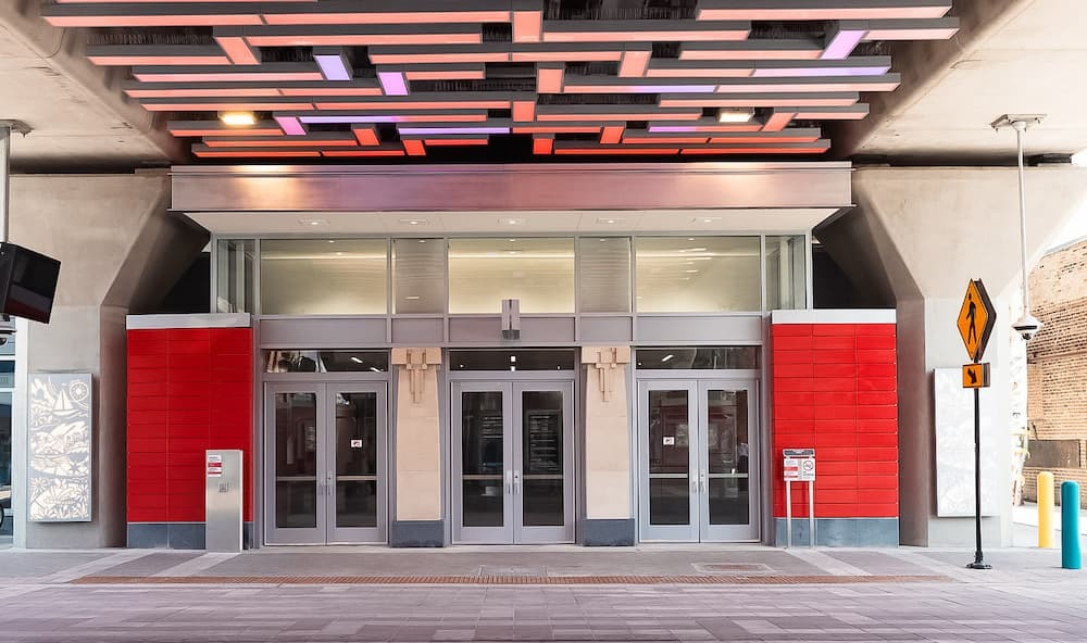 Argyle station, three doors with red trim and multicolored lights overhead.