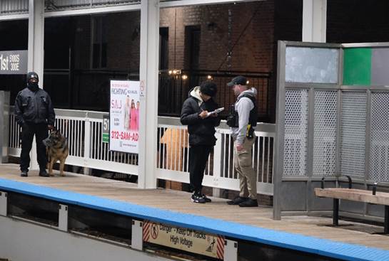 Officer speaking with rider on train platform